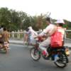 bikes and passengers in traffic with no helmets